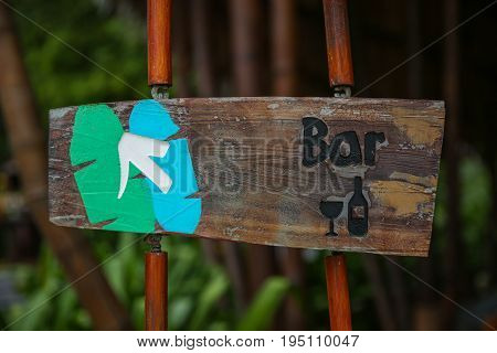 Vintage Looking Bar Sign With An Arrow Pointing Direction