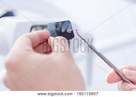 Cropped Shot Of Dentist Pointing At Xray Picture Of Teeth With Dental Scraper