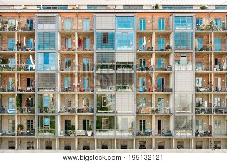 Modern renovated residential building with balconies. Former old historic industrial building. Germany.