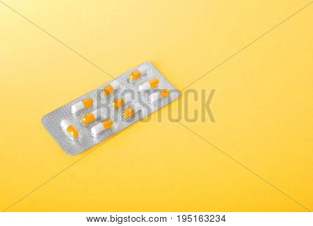 Pills, painkillers, drugs, vitamins, tablets in capsules. Close-up various colorful prescripted drugs. Orange and white aspirin in blisters. Pharmaceutical supplement. Medical vitamins.