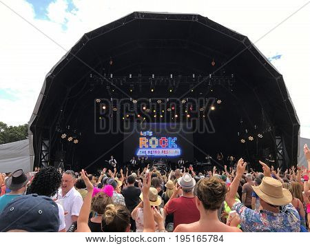 SOUTHAMPTON UK - July 8 2017: Lets Rock Southampton 80s music festival in Southampton UK on a cloudy day with some blue sky. Stage wtih fans dancing and having fun.