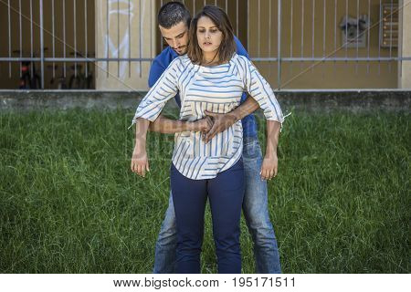 guy making the heimlich maneuver to a girl while she's choking