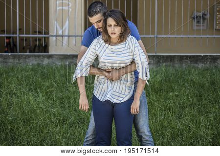 guy making the heimlich maneuver to a girl while she's choking