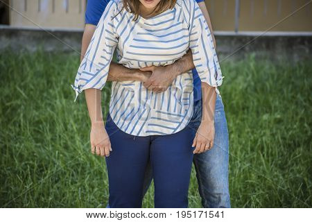 guy making the Heimlich maneuver to a girl while she's choking