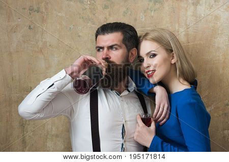 Man Drinking Wine From Bottle And Girl Smiling With Glass