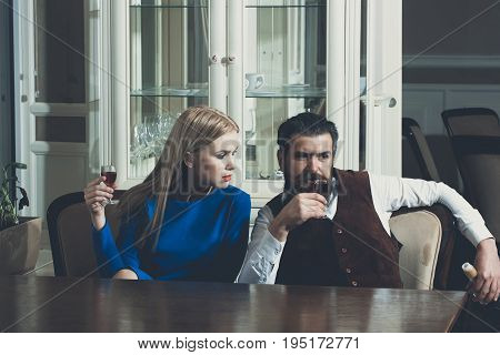 Woman And Hipster Drinking Wine In Restaurant