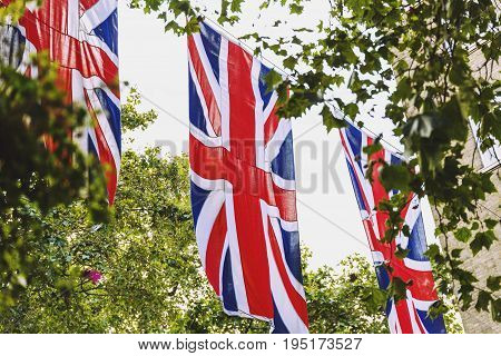 LONDON UNITED KINGDOM - August 12th 2016: Union Jack flag waving above Bruton Street in the affluent area of Mayfair in London city centre