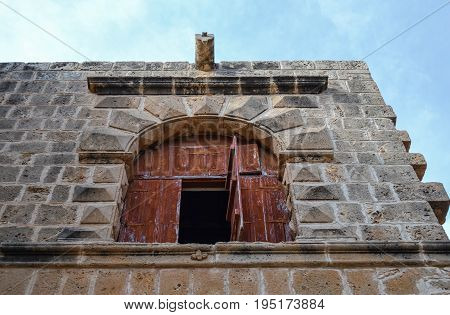 Window / arch high in the wall of an ancient castle. bottom view