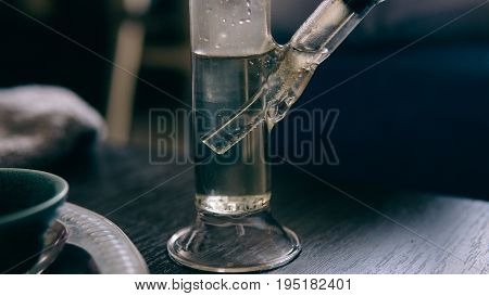.smoking Marijuana With A Bong Close-up . Legalization And Dependence On Light Drugs