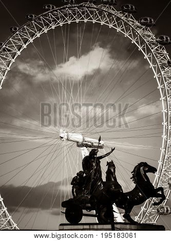 London UK - February 23 2016: The statue of Boadicea underneath Big Ben in Westminster London UKwith the London Eye behind