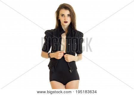 Cute serious woman in black jacket and panties posing on camera isolated on white background