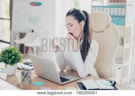 Morning In The Office. Young Pretty Business Lady Lawyer Is Yawning At Her Work Place With Cup Of Co