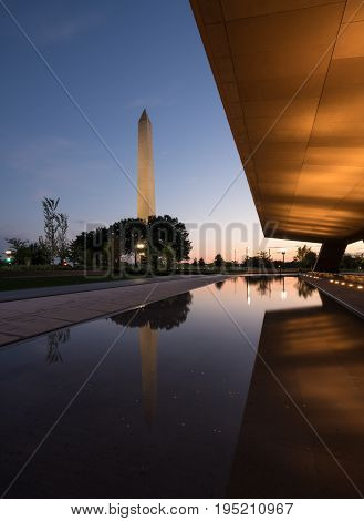 Reflection of Washington Monument in calm reflecting pool at sunset