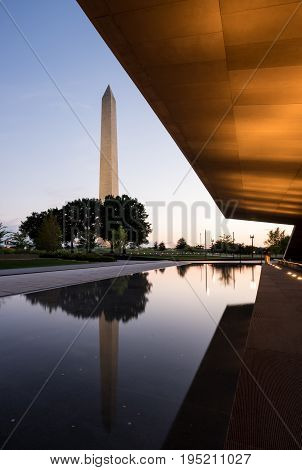 Reflection of Washington Monument in calm reflecting pool at sunset