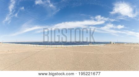 a panoramic view of solar panels on the gobi desert new energy background