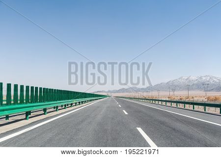 highway on gobi desert long road with wilderness background