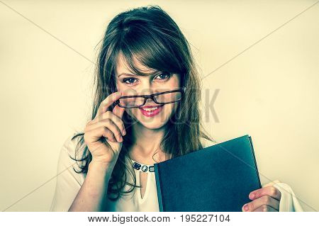 Happy graduate woman with her dissertation work on white - education concept - retro style