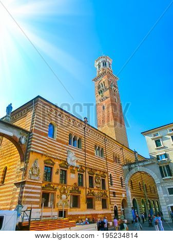 Verona, Italy - September 22, 2014: Piazza delle erbe in Verona street and market view with Lamberti tower, tourist destination in Veneto region of Italy at September 22, 2014