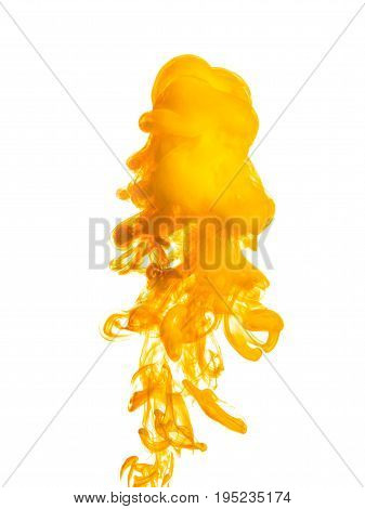 Ink swirl in water isolated on white background. The paint in the water. Soft dissemination a droplets of colored ink in water close-up. Abstract background. Explosion of splashes yellow acrylic ink.