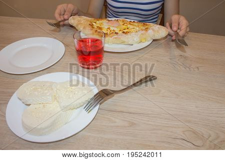 Adjarian khachapuri with eggs on the table. Delicious homemade khachapuri in Adjarian