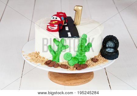 Festive cake with a birthday car for 1 year.