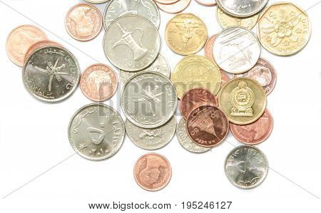Coins from many countries on a white background.