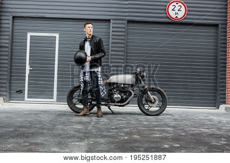 Brutal Man Near His Cafe Racer Custom Motorbike.
