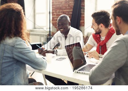 Teamwork concept.Young creative coworkers working with new startup project in modern office.Group of people analyze data on desktop computer.