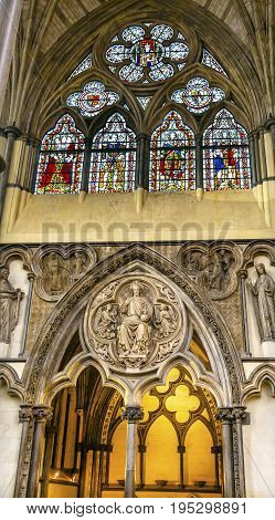 LONDON, ENGLAND - JANUARY 16, 2017 Interior Arches Stained Glass Jesus Statue 13th Century Chapter House Westminster Abbey Church London England. Westminister Abbey has been the burial place of Britain's monarchs since the 11th century and is the setting 