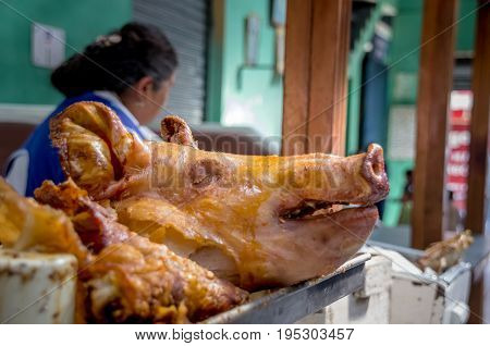 Delicious hornado roasted pork, over a silver tray, ecuadorian traditional typical andean food located in the municipal market in San Francisco in the city of Quito.