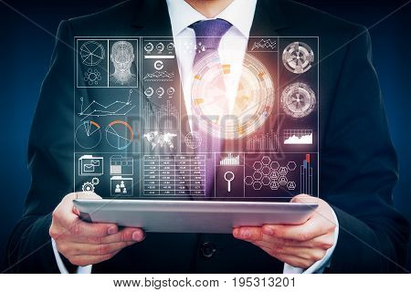 Businessman holding tablet with abstract digital business proection on screen. Touchscreen and technology concept
