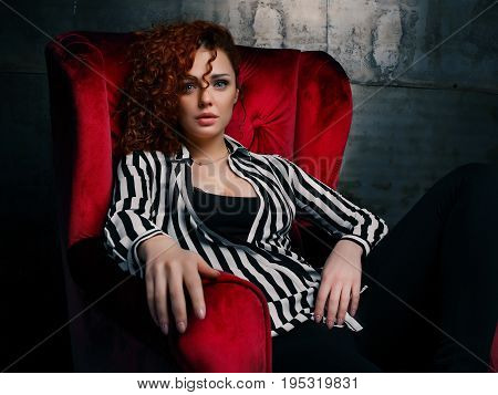 woman siting on red chair in nice interier