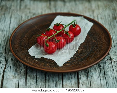 Bunch of fresh tomatoes and tomato juice in glass on wooden table