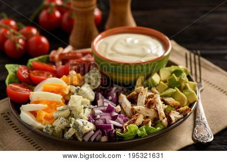 Salad cobb- avocado, tomatoes, bacon, chicken and onion.