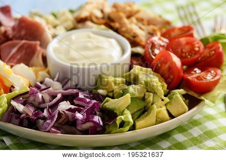 Salad cobb- avocado, tomatoes, bacon, chicken and onion.