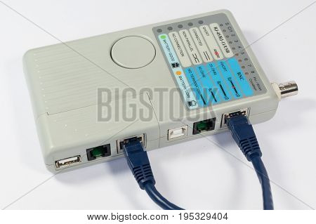 Cable Tester with Ethernet cable attached on white background