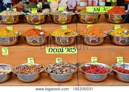 Spices at Mahane Yehuda market in Jerusalem. On tablets are written the prices for cinnamon pepper chili ginger mushrooms turmeric and various mixtures of spices for different meats