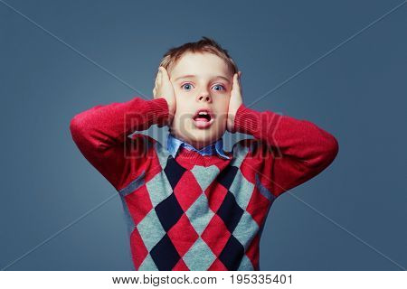 scared boy isolated against grey background