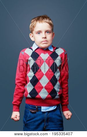 embarrassed angry boy isolated against grey