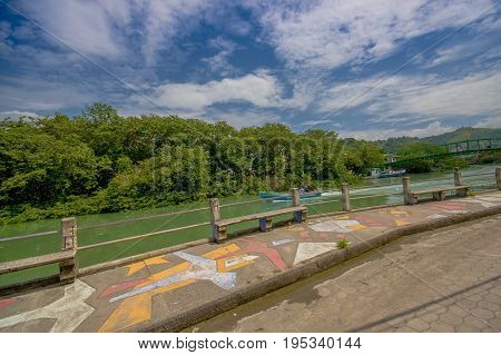 ATACAMES, ECUADOR - March 16, 2016: Unidentified man enjoying the view near of a river in Atacames, Ecuador.