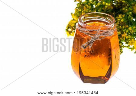 St. John's wort in glass jar on white background. Studio Photo
