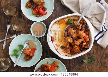 Dinner eating table with baked chicken breast with vegetables and white wine top view