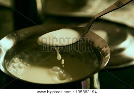 White sauce mixed in a bowl with a spoon, ready to be served.