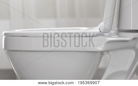 Part of white ceramic toilet bowl close-up.