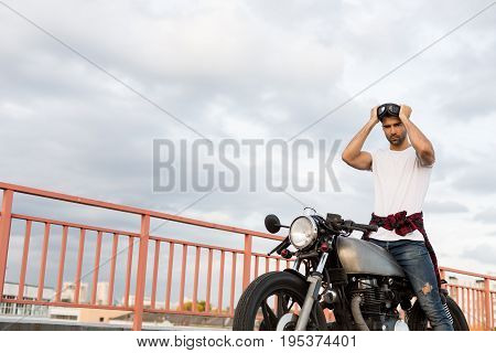 Brutal Man Near His Cafe Racer Custom Motorbike.