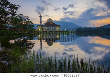 Mirror Reflection Of Beautiful Mosque During Sunrise.