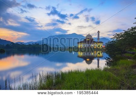 Mirror Reflection Of Beautiful Mosque During Sunrise.