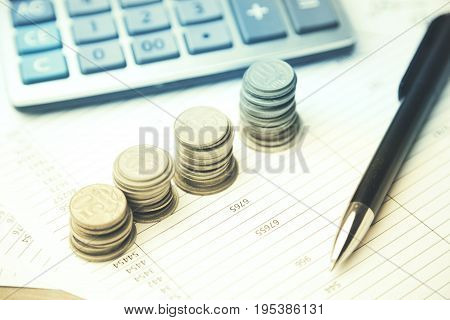 moneycalculator and pen on the financial papers