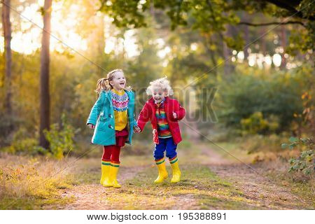 Kids Play In Autumn Park. Children In Fall.