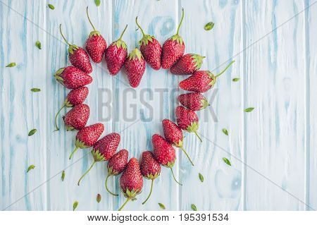 Fresh Strawberries Array Heart Shape On Old Wooden Background
